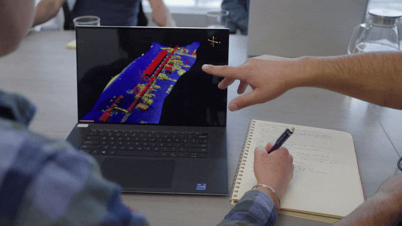Lidar map of site on laptop as person takes notes