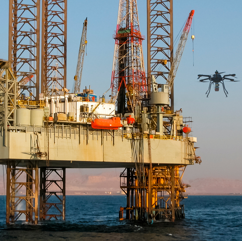 Bridger drone flying next to offshore rig at sunset