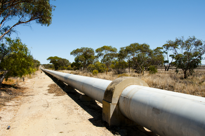 Pipeline On Field Against Clear Blue Sky-1